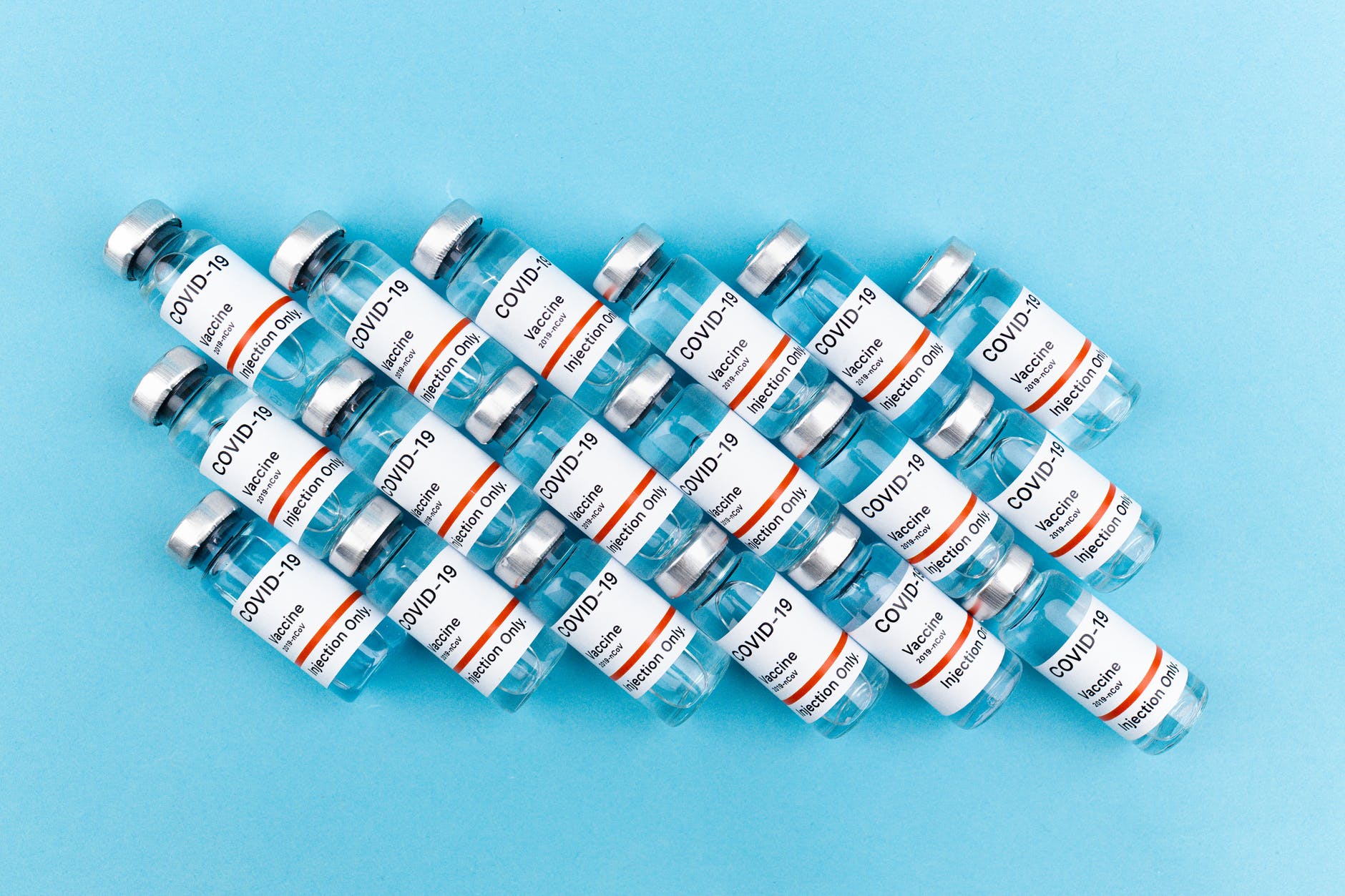 vaccine bottles on blue background
